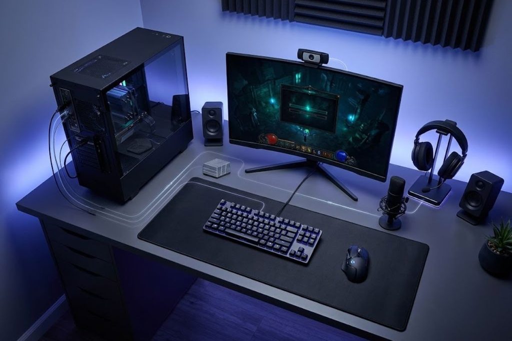 Gaming PC setup with monitor, keyboard, mouse, headset and webcam.